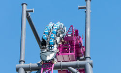 The train crests the lift hill for the first time ever. DC Rivals HyperCoaster commences testing